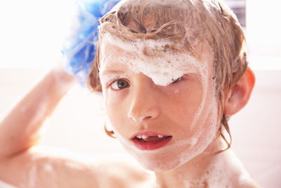 Portrait of young boy bathing