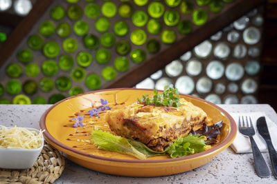 Close-up of food in plate a lasagna on table