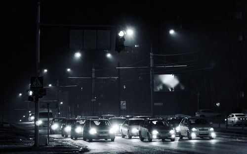 Cars moving on city street at night