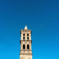 Low angle view of built structure against clear blue sky
