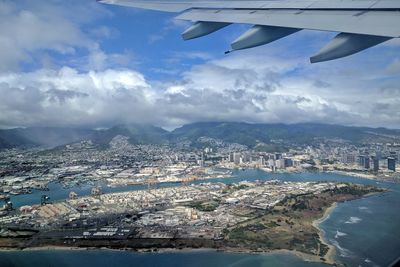 Aerial view of sea and cityscape against sky