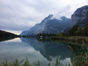 Scenic view of lake and mountains against sky