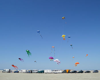 Low angle view of kite against clear blue sky