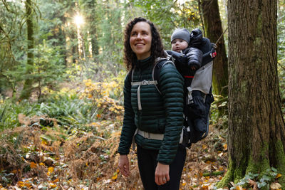 Portrait of young woman standing in forest