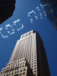 Low angle view of office building with single word of vapor trail in sky