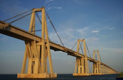 Low angle view of suspension bridge against sky