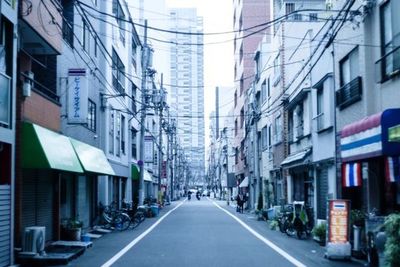 Road amidst buildings in city