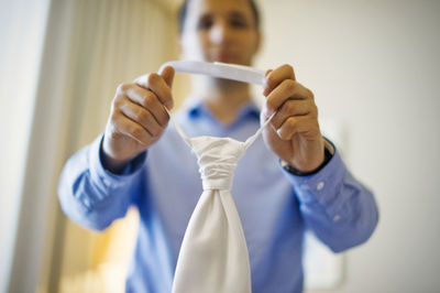 Close-up of man showing necktie