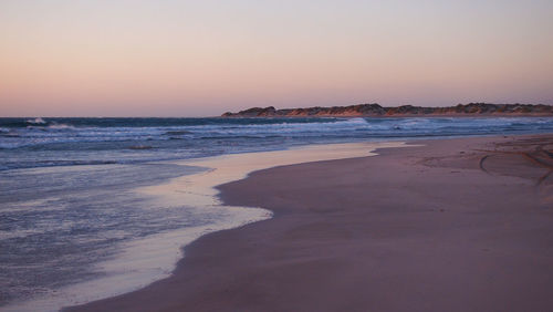 View of beach at sunset