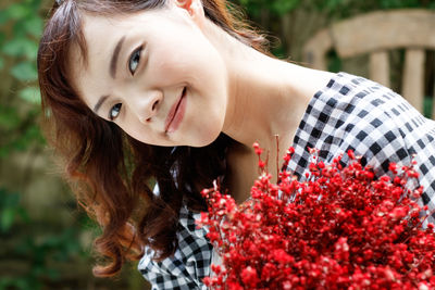 Portrait of woman with red flowers