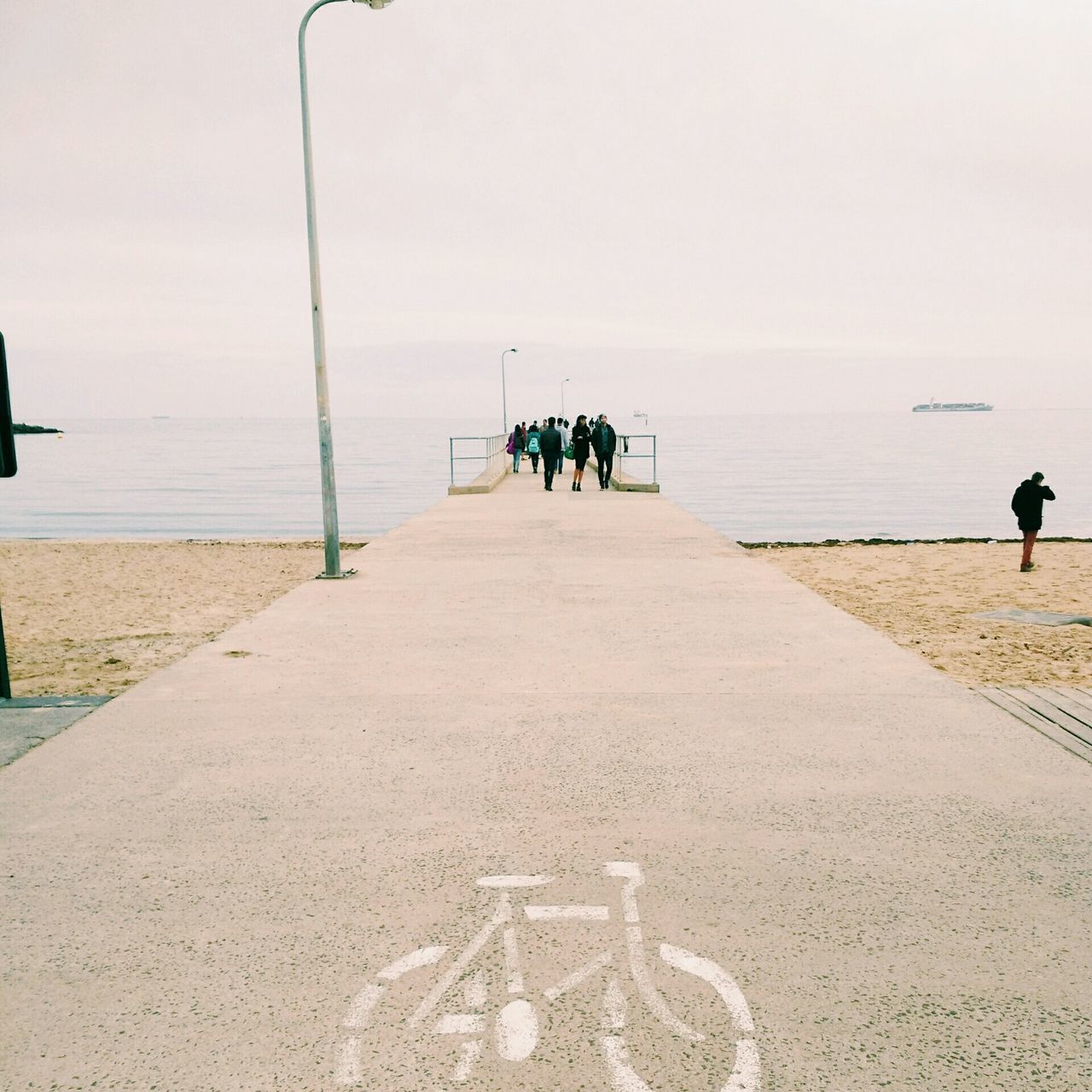 sea, men, water, clear sky, lifestyles, the way forward, horizon over water, leisure activity, rear view, person, walking, copy space, full length, sky, standing, pier, beach, day