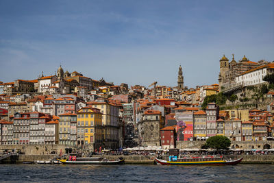 Boats in river with buildings in background