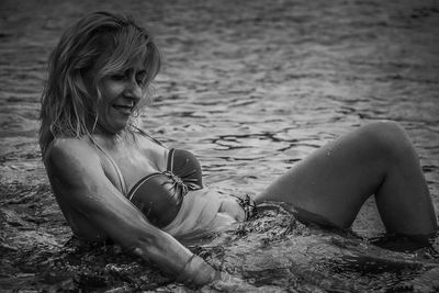 Young woman sitting on beach