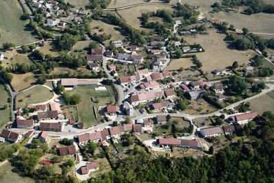 High angle view of buildings and trees on field