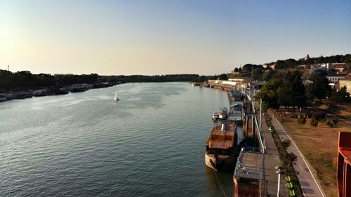Boats in river against clear sky