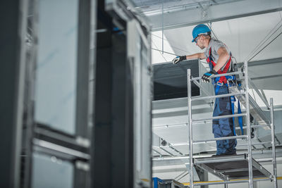 Low angle view of man working in factory