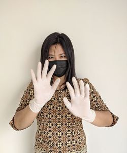 Portrait of beautiful young woman against white background