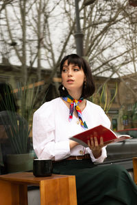 Portrait of woman standing on table