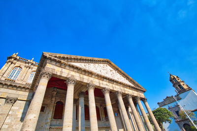 Low angle view of building against blue sky