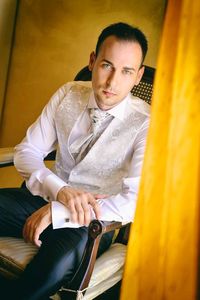 Portrait of young man sitting outdoors