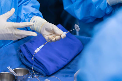 Midsection of doctor examining patient in hospital