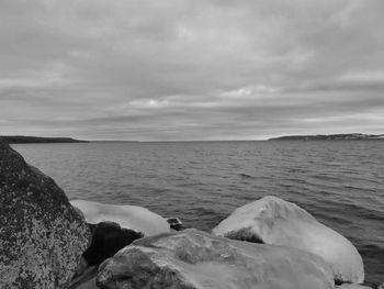 Scenic view of sea against cloudy sky