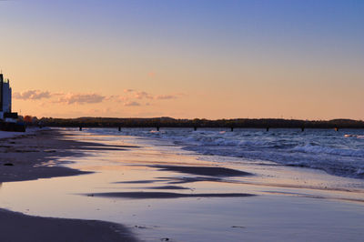 Scenic view of beach against sky during sunset