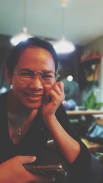 Portrait of woman holding smart phone
