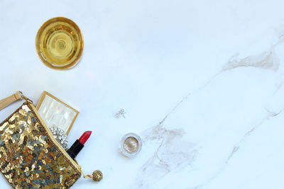 High angle view of various objects on white marble