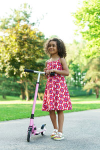 Portrait of young woman standing on road