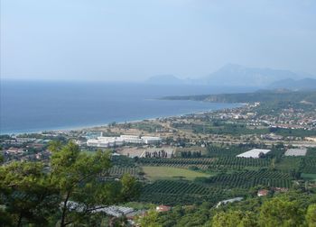 High angle view of townscape by sea against sky