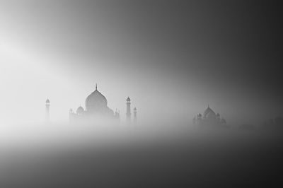 View of mosque against sky during foggy weather