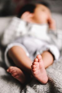 Baby girl sleeping on bed at home