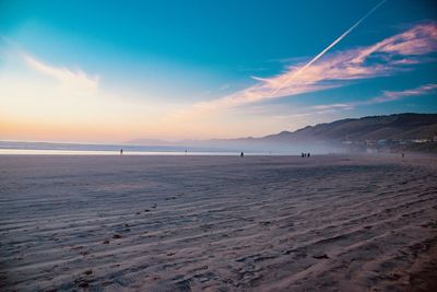 Scenic view of beach against sky during sunset