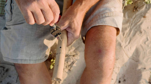 Midsection of man holding hands