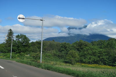 Street light by road against sky
