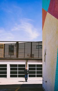 Full length of man on building wall against sky