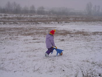 People standing on snowy field