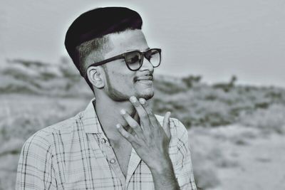 Close-up of young man standing at beach