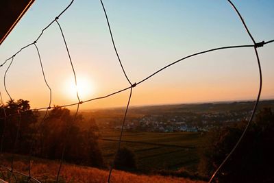 Scenic view of field against clear sky during sunset