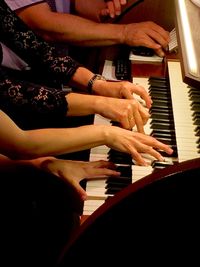 Midsection of woman playing piano