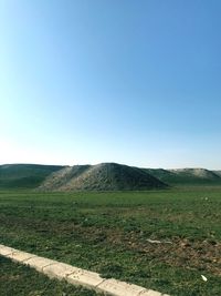 Scenic view of field against clear blue sky