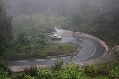 High angle view of winding road amidst trees