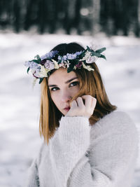 Portrait of young woman wearing flowers