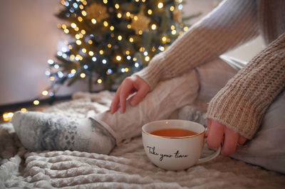 Conceptual take your time girl holding a cup of tea