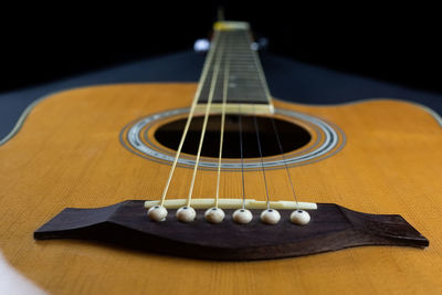 Close-up of guitar on table