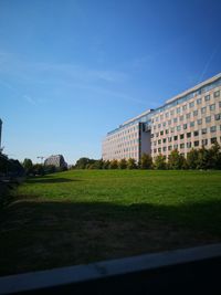 Buildings in city against clear blue sky