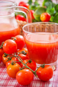 Close-up of tomatoes in glass jar on table