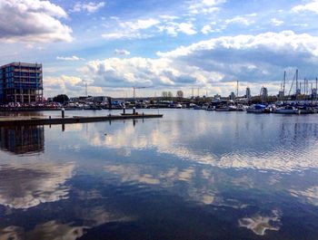 View of harbor against cloudy sky