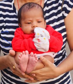 Midsection of mother with baby